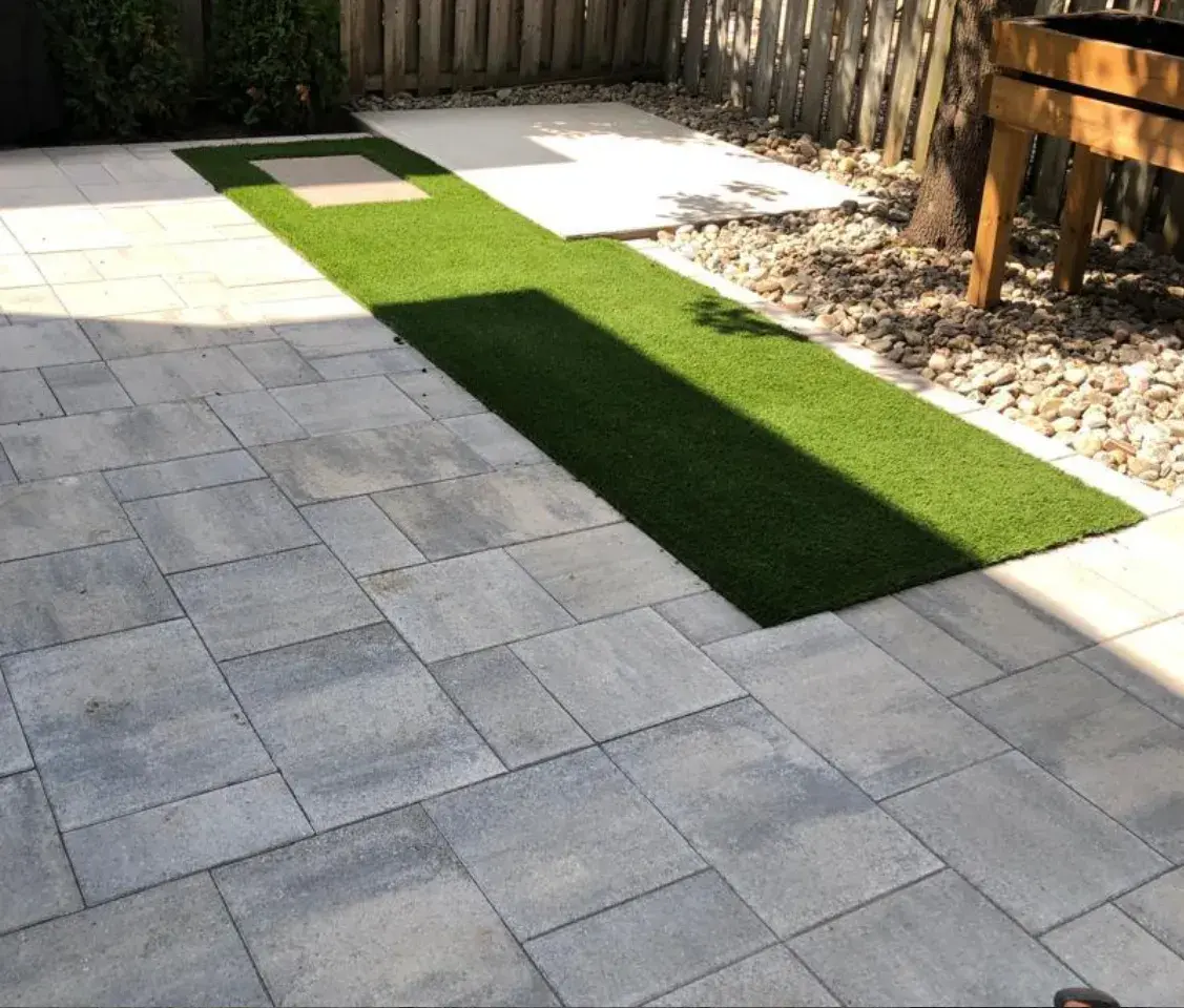 Interlock paver patio with artificial turf strip