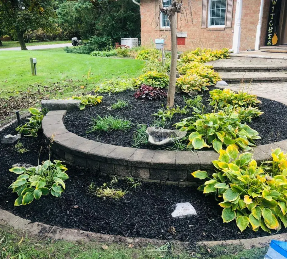 Circular raised garden bed with layered plantings